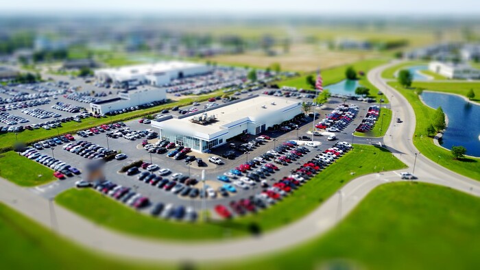 Aerial view of a franchise dealership lot full of inventory